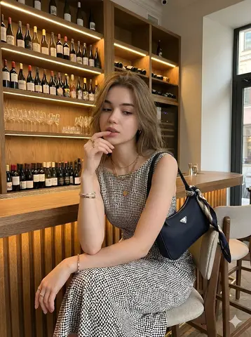 Young beautiful woman with long wavy hair, elegant sleeveless