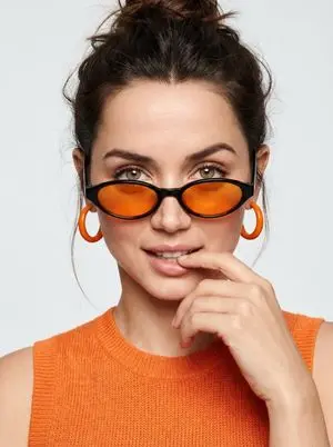 High-fashion editorial portrait with vivid orange accents