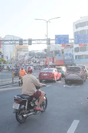 Edit city photo into rainy scene with Vietnamese bikers