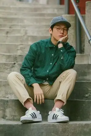 Introspective Young Man on Concrete Stairs
