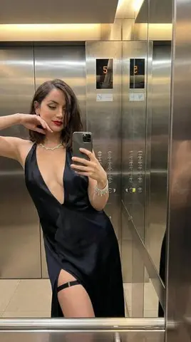 Luxury Elevator Mirror Selfie in Deep V-Neck Dress