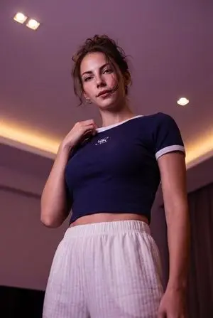 Low-angle stylized portrait of a young woman in a dim room