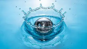 Metal ball splashing into water (slow-motion feel)
