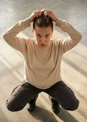 Editorial realism portrait of a woman tying her hair