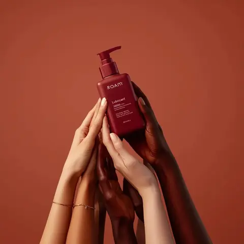 Minimalist product photography of a matte red pump bottle