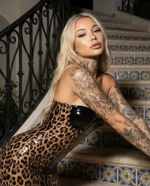 Glamorous Blonde Woman in Leopard Latex with Floral Tattoos