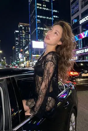 Nighttime Urban Fashion Editorial in Luxury Sedan Prompt