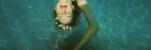 Anonymized Swimmer in Teal Pool