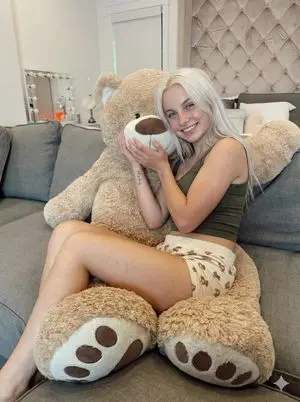 Candid Snapshot of Woman Hugging a Giant Teddy Bear