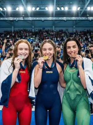 Cinematic sports photo of celebrity swimmers on a podium