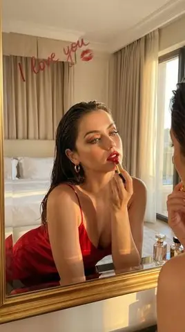 Cinematic Portrait of a Woman Applying Red Lipstick (Alternative)