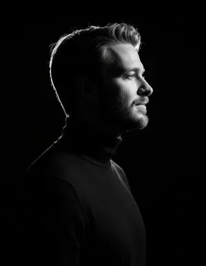 High-contrast rim-lit black and white conceptual side-profile portrait