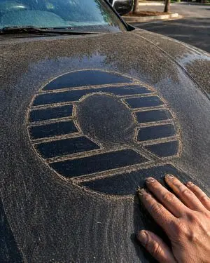 Dust-Drawn Symbol on Car Hood