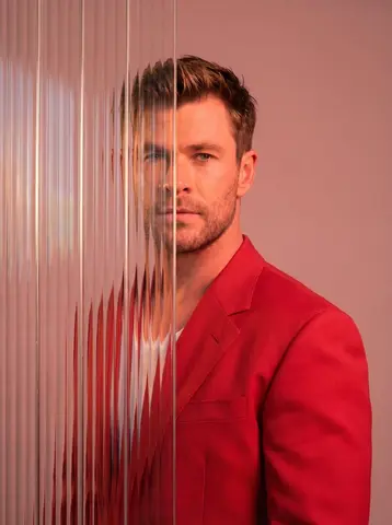 A striking editorial portrait photograph of a person wearing