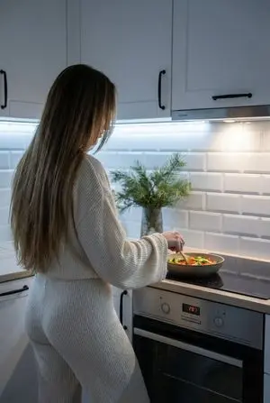 Candid Shot of Woman Cooking in Modern Kitchen