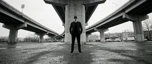 High-Contrast Documentary Photo Under a Brutalist Overpass