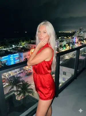 Paparazzi-Style Photo of a Woman on a High-Rise Balcony