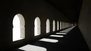 Dramatic Stone Corridor With Arched Windows