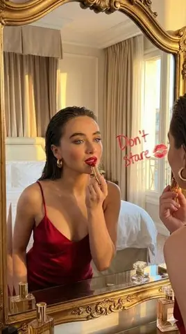 Cinematic Portrait of a Woman Applying Red Lipstick in a Mirror